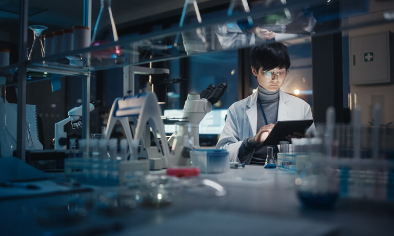 Digital transformation in clinical research&mdash;researcher managing trial randomization and supply logistics through RTSM software.